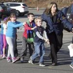 Connecticut State Police lead children from the Sandy Hook Elementary School following a shooting. (AP Photo/Newtown Bee, Shannon Hicks) MANDATORY CREDIT
