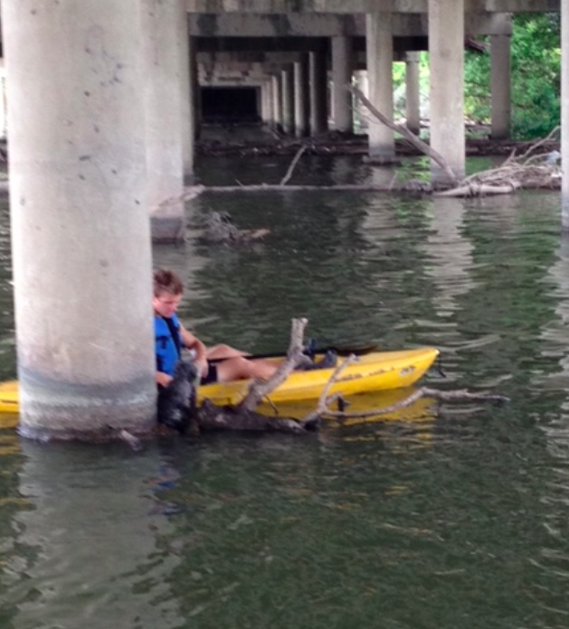 Benjamin Magill paddles to the rescue of a drowning puppy under the Mockingbird Bridge at White Rock Lake 