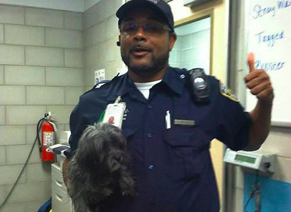 Officer Lee Pogue with rescued pup at the Dallas animal shelter: Facebook