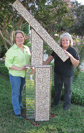 Sisters Lynn Reagan and Elizabeth “Sissy” Bingham and their sculpture, “Timeless.”