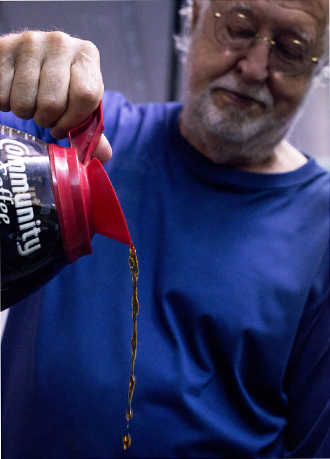 Ted De Bosier chips in by pouring coffee. Photo by Danny Fulgencio 