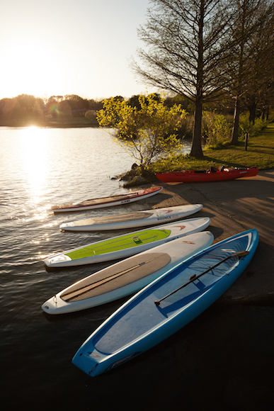 Paddle boards lay strewn on a dock at White Rock Lake. (Photo by Rasy Ran)