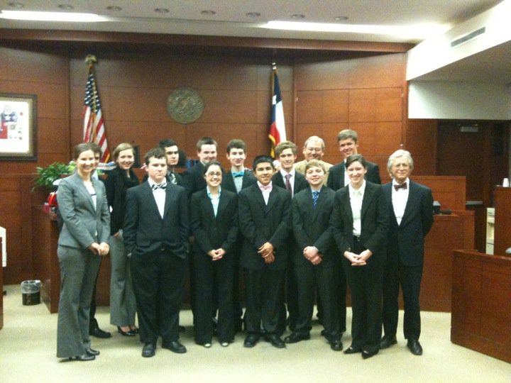 Woodrow's Mock Trial team advances to State competition March 4-5. Team members and coaches include (front, from left) Woodrow sponsor Catherine Pate, Clark Wamre, Kristen Arnold, Harvey Tovar, Austin Timms, Emily Ziegler and coach Joe Smith; (back, from left) Kimberly Tepera, Jake Schutze, Cal Little, Ricky Nichols, Ben Tompkins, coach Mike Buchanan and Brian Tepera.