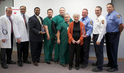 Jeanne Holms, pictured with Doctors Hospital and fire department personnel