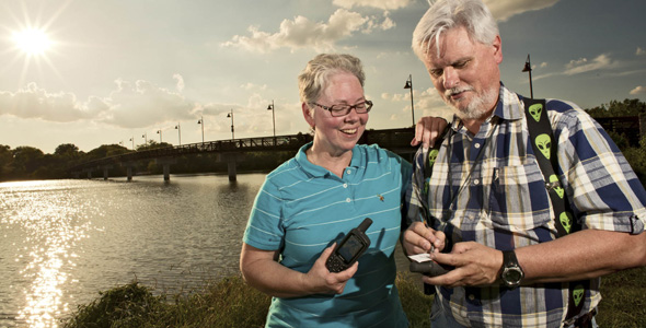 Geocachers Paulette Deutman and Martin Lollar hunt for GPS coordinates near White Rock Lake.