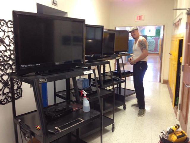 A William Lipscomb Elementary dad helps install new TVs. Photo taken from Facebook.