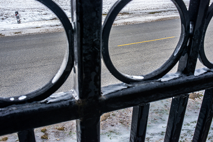 At White Rock Lake, two runners were not framed in a wrought iron fence.