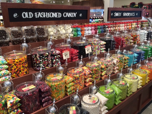 Glass jars full of candy makes up one row of The Fresh Market's bulk section.