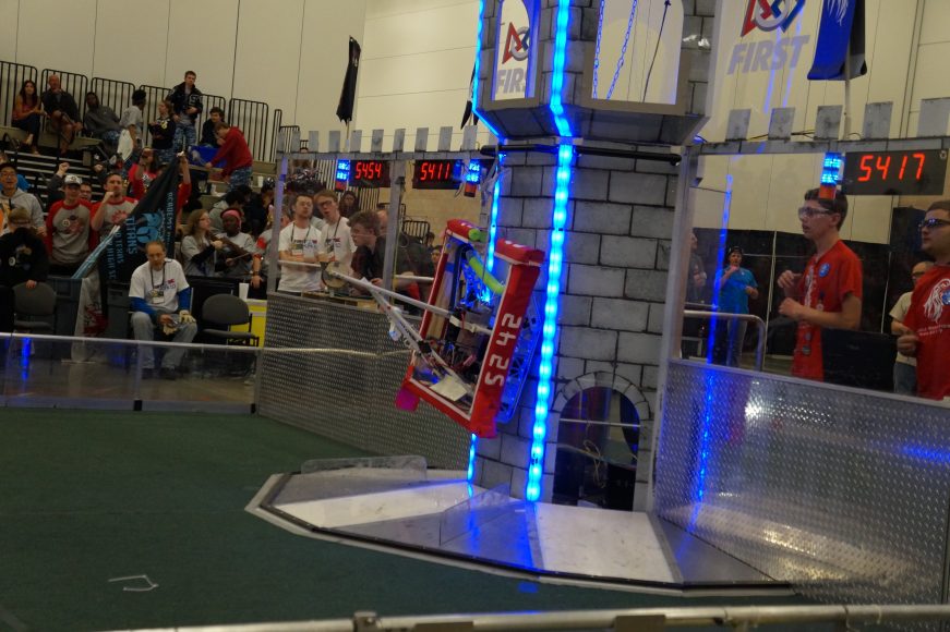 Robocats robot scaling the wall at Robotics First.