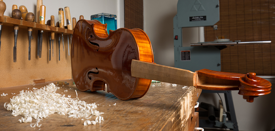 A violin in its varnished state, waiting to be finished out through a UV lightbox. (Photo by Rasy Ran)