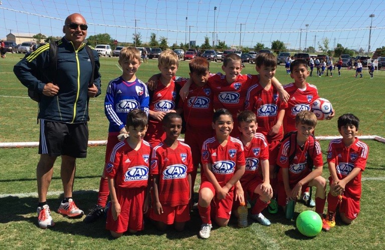 FC Dallas Central team includes kids from across East Dallas, pictured here with coach Daniel Rivas.
