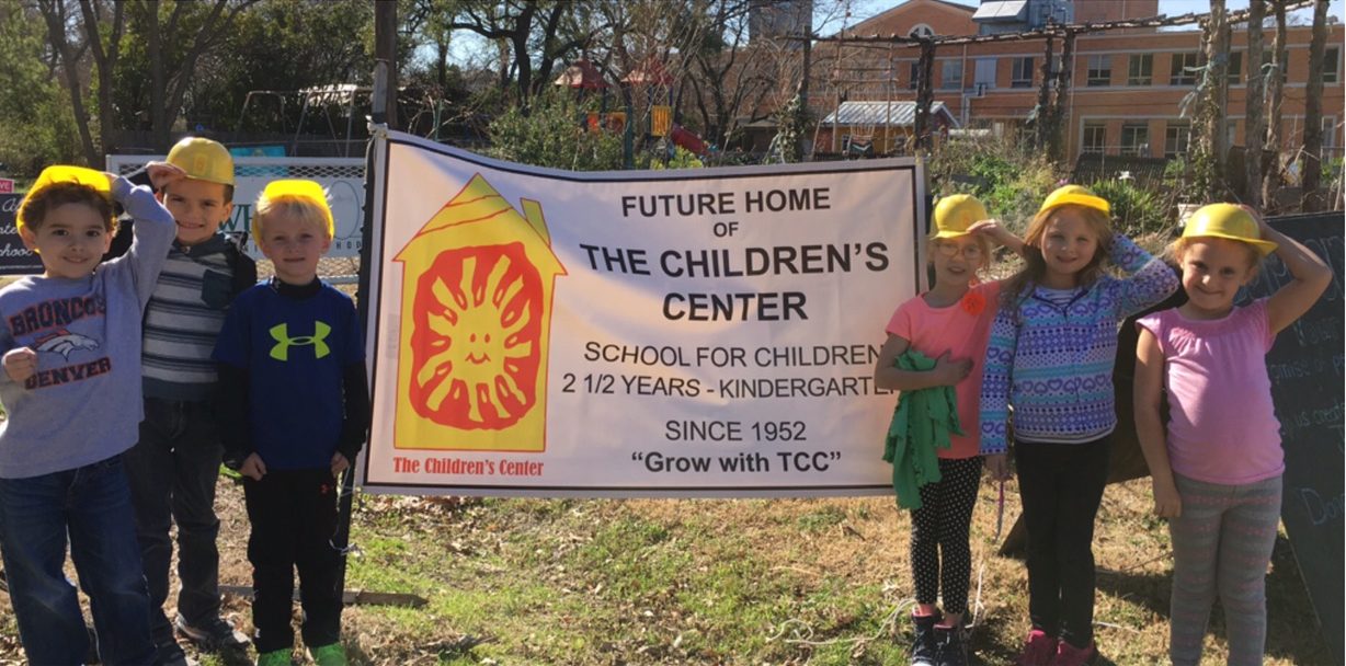 Students at the Children's Center wearing hardhats at the site of their new location.