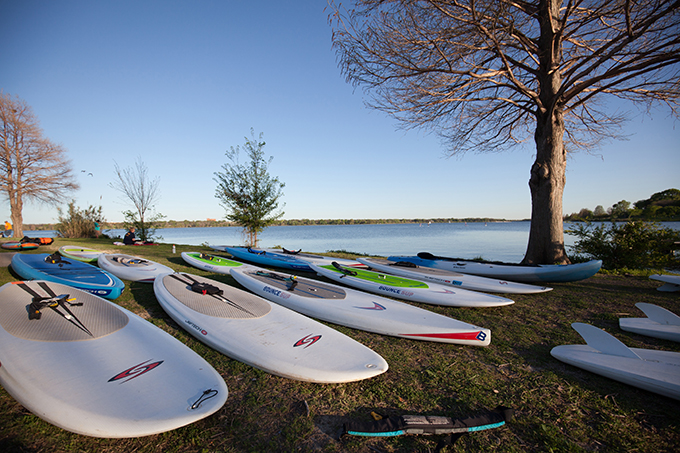 Paddle boards lay strewn on the shores of White Rock Lake. (Photo by Rasy Ran)