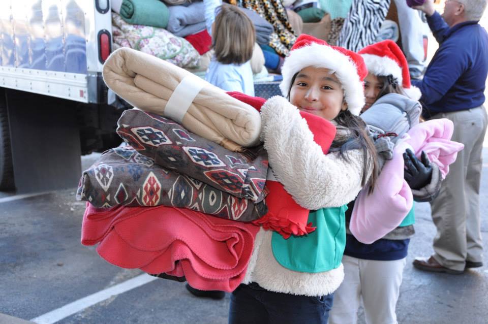 Girl Scouts collect blankets during the Share the Warmth Drive. Image courtesy of Revolution Public Relations. 