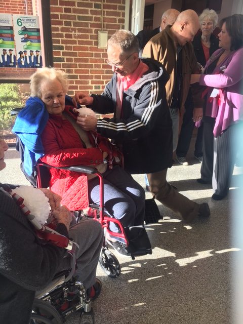 Aaron Schmidt of C. C. Young pins a homecoming mum on Sally Green Metheny, Woodrow Wilson's class of 1953.
