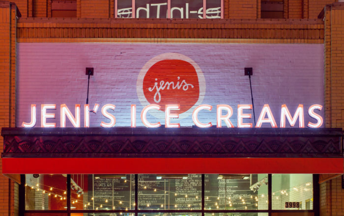 A storefront which says Jeni's Ice Creams in thick, neon capital letters.