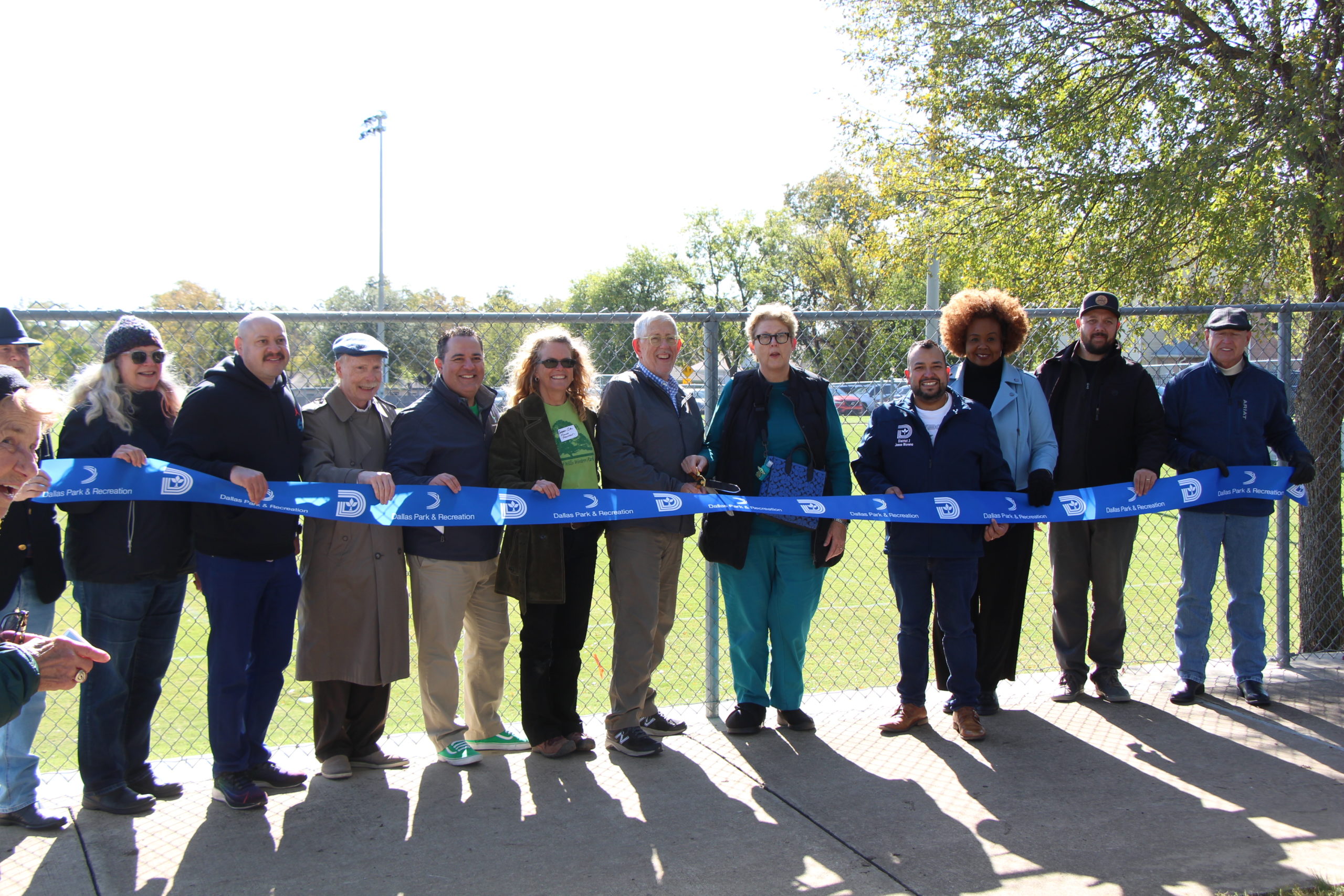 Stakeholders cut the ribbon on the renovated soccer field at Willis Winters Park