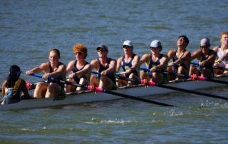 A boat of eight rowers and one coxswain rowing at the Waco Rowing Regatta.