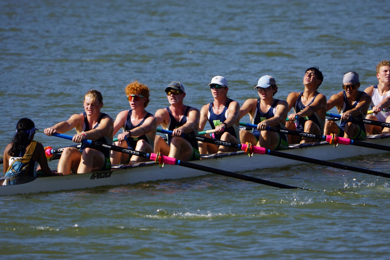 A boat of eight rowers and one coxswain rowing at the Waco Rowing Regatta.