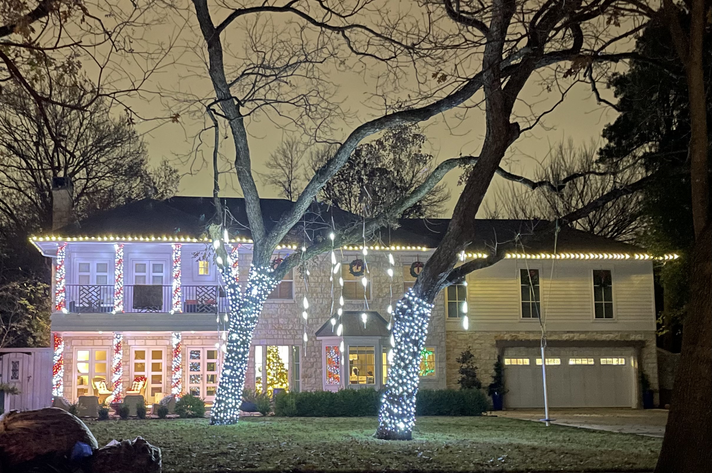 Lights on the house and hanging from trees in Forest Hills.