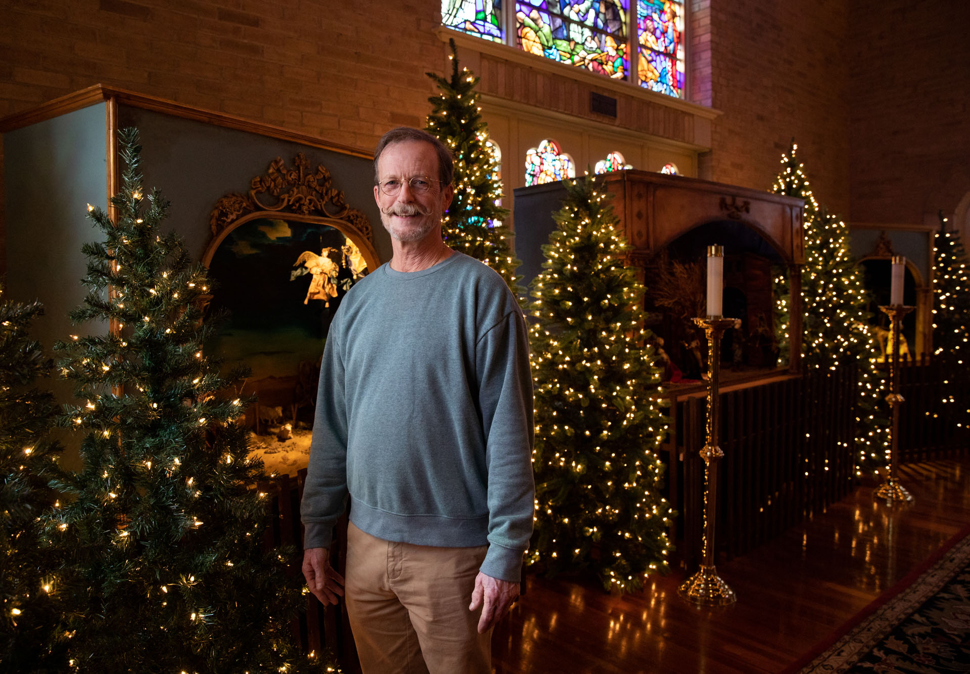 Tommy Bourgeois stands in front of the Christmas crèches at St. Matthew's Cathedral