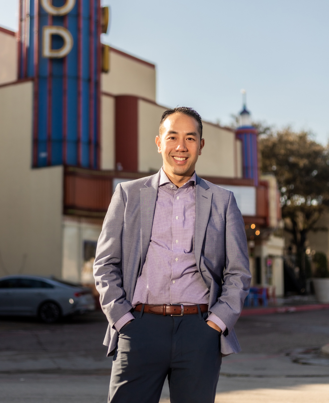 Jimmy Tran stands in front of the old Lakewood Theater marquee