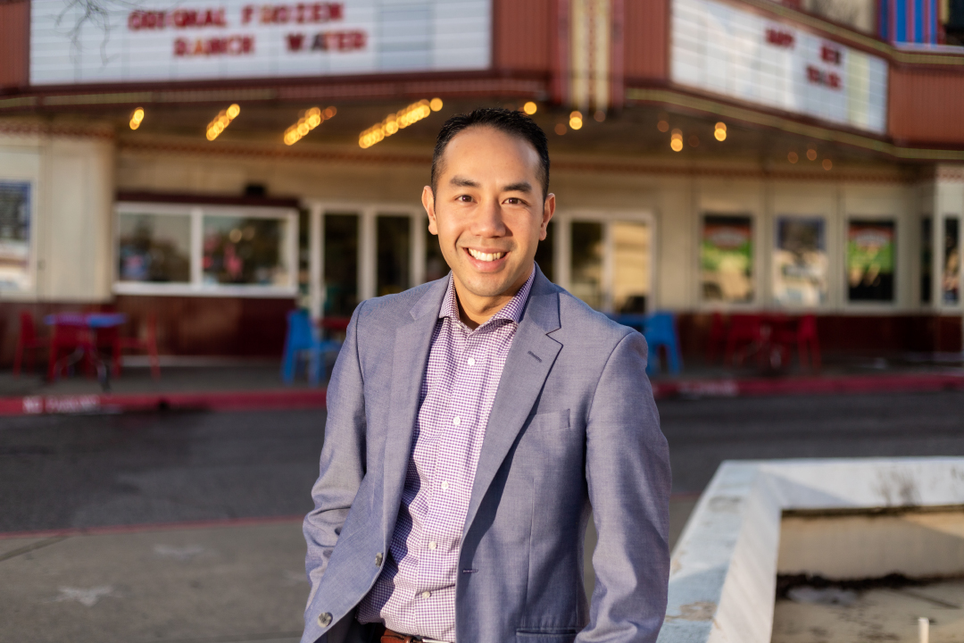 Jimmy Tran stands in front of the old Lakewood Theater marquee