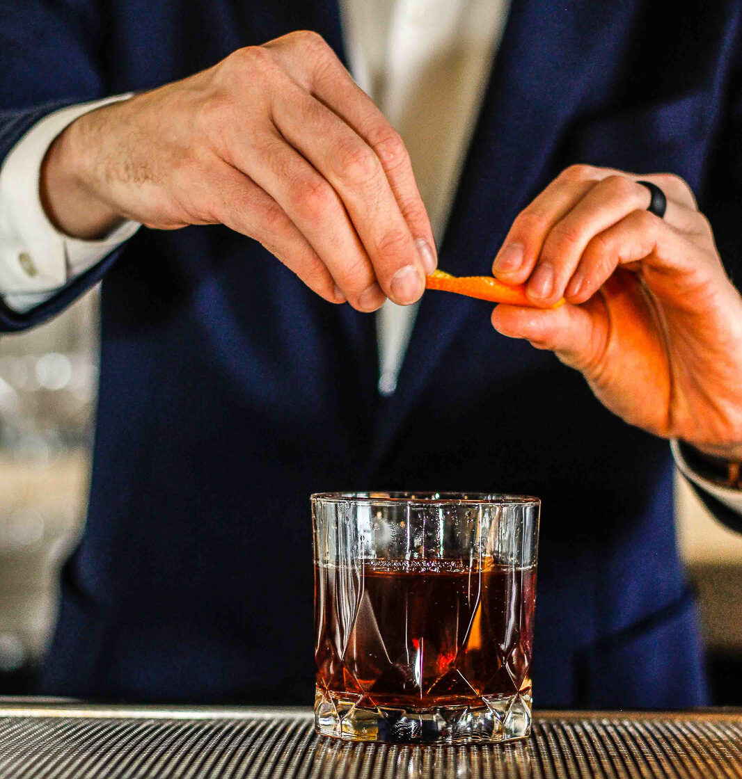 The Red Eye Flight cocktail is a reference to the thought that a New Zealander flew a plane before the Wright Brothers. The drink includes Angel’s Envy Bourbon, Campari and espresso. Photography by Kelsey Shoemaker.