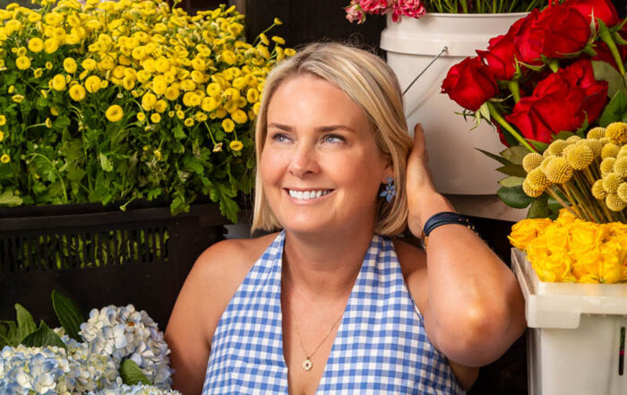 Kristee Rouse of En Fluer is surrounded by flower. Photo by Yuvie Styles