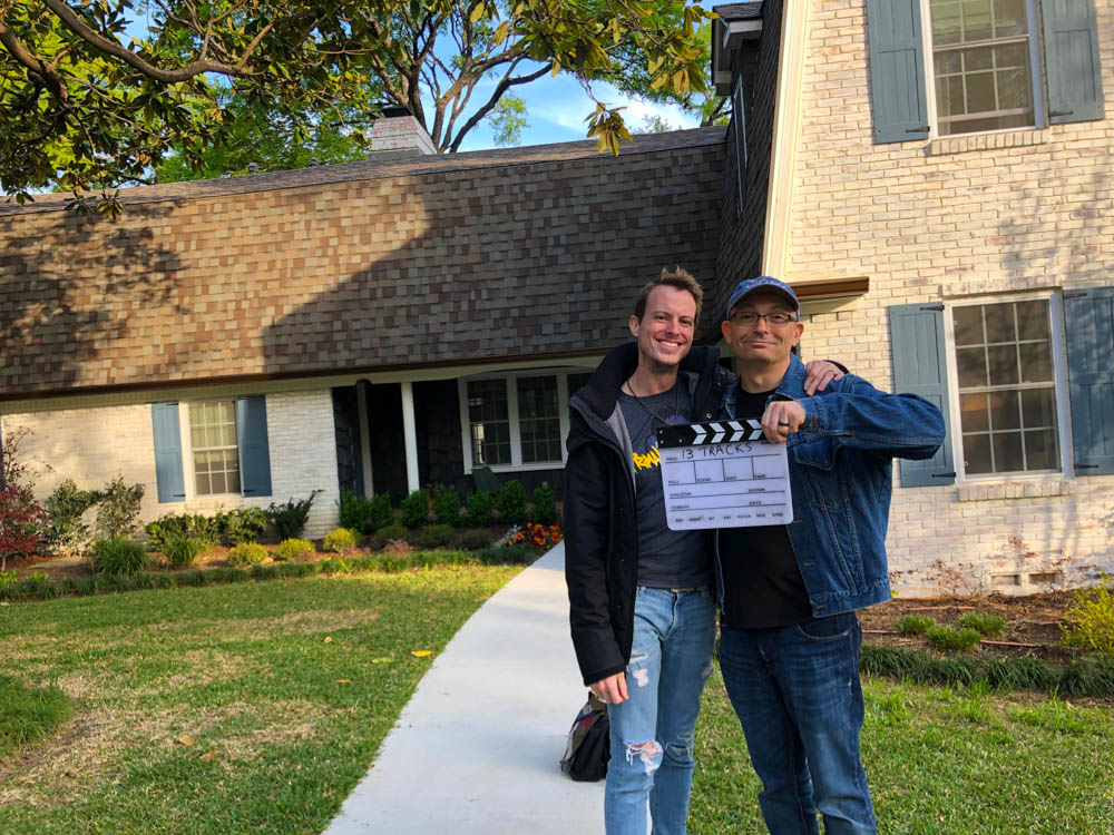 2 men in front of a home
