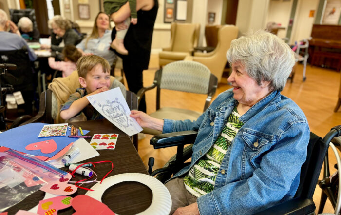 Resident of Juliette Fowler admires a child's drawing. Sponsored content.