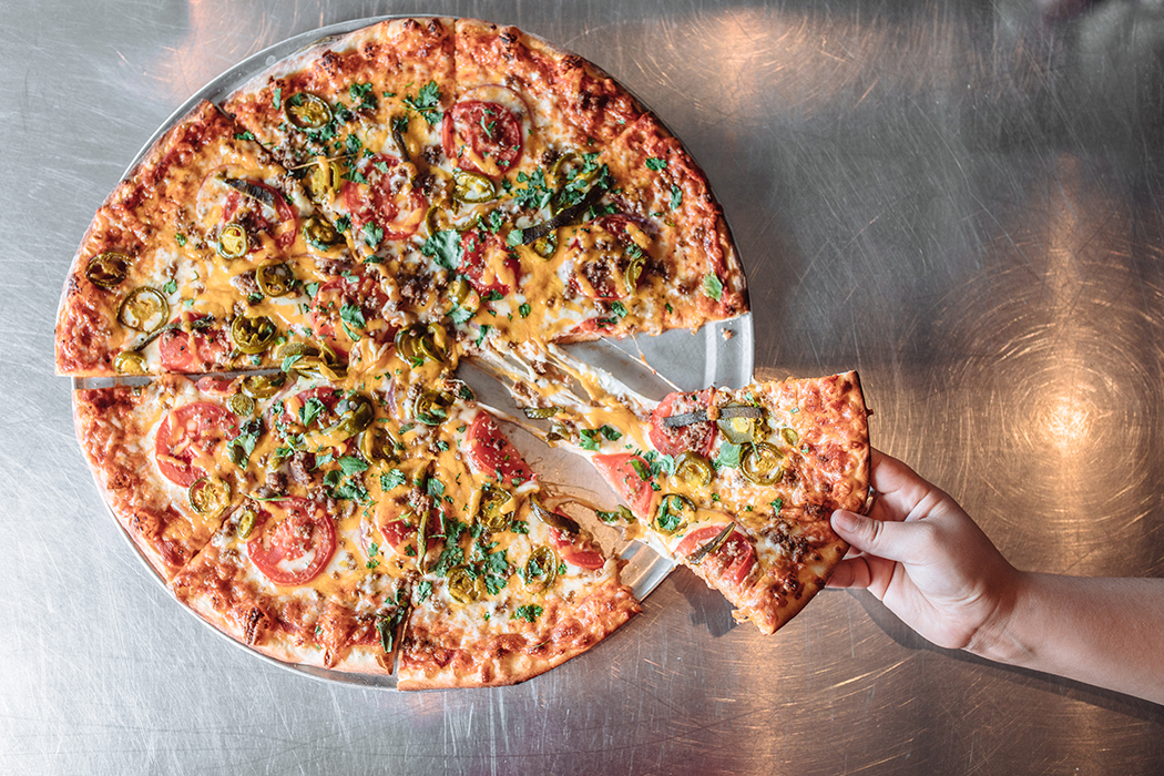 The Mexican Pizza is a spicy and savory combination of poblano peppers, jalapenos, cilantro, hamburger and cheddar at Greenville Avenue Pizza Company (Photo by KathyTran)